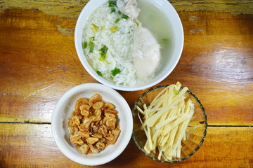 boiled rice with chicken leg with slice ginger and fried garlic on bowl