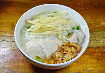 boiled rice with chicken leg topping slice ginger and fried garlic on bowl