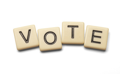 Vote spelled out with lettered tiles on white background. Clipping path included. 