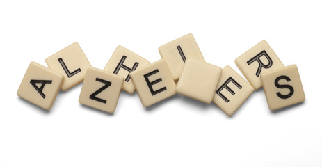 Alzheimers spelled out with lettered tiles on white background. Clipping path included. 
