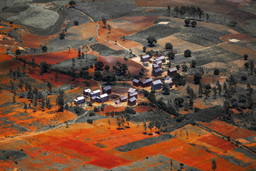 Traditional Malagasy village among red soils. Madagascar