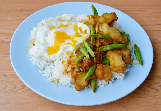 spicy stir fried crispy pork and yard long bean in curry and creamy egg yolk