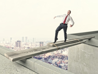 businessman crosses  improvised bridge. concept caution, danger challenge