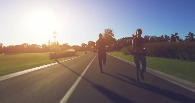 Couple jogging in the park. 4k, 25 fps