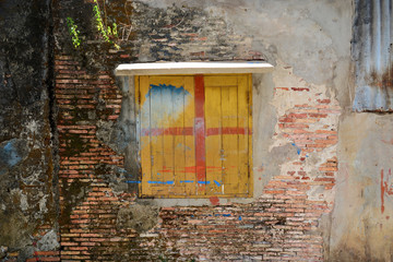 Cracked concrete on old brick wall with window texture backgroun