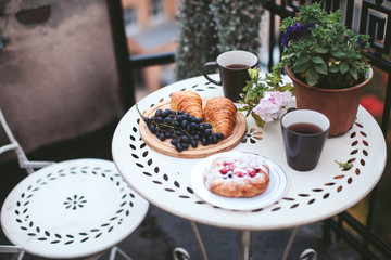 breakfast pastries with tea and grapes on the balcony overlooking the city