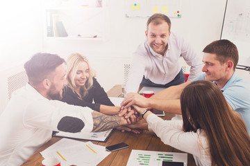 Teamwork and teambuilding concept in office, people connect hand