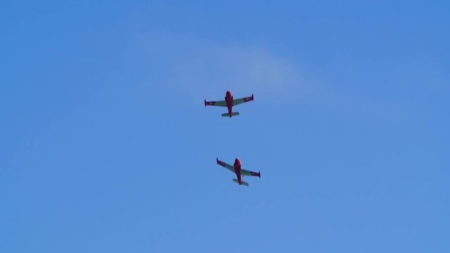 Slow motion view of acrobatic airplanes at an air show