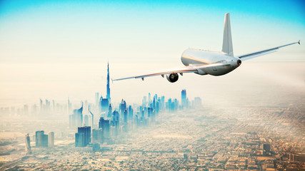 Naklejka premium Komercyjny samolot latający nad nowoczesnym miastem