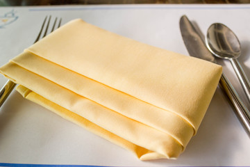 yellow napkin with folk and spoon