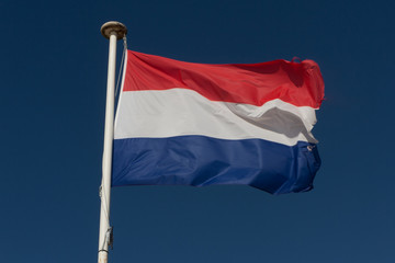 Fototapeta na wymiar French flag in front of blue sky - French national flag