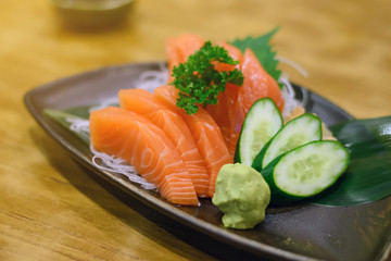 Salmon sashimi with Wasabi on pottery dish