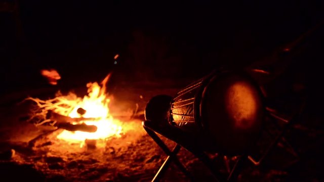 Indian drum against a background of fire. The flame shines through the skin and is reflected in the patterns.