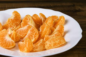 fresh tangerine slices on a white plate