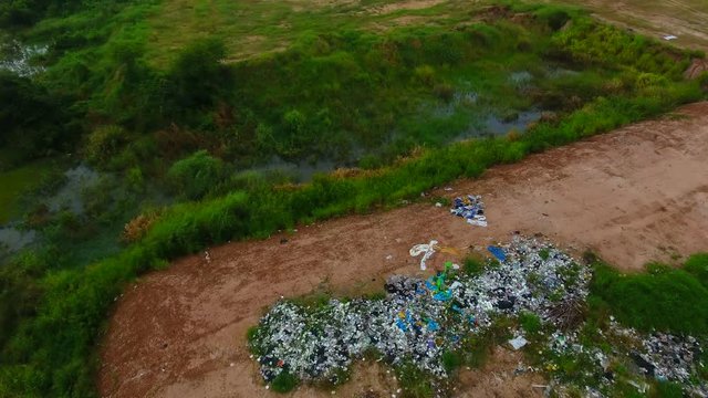 Camera is flying over  dump of domestic garbage