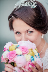 Wedding. Beautiful bride with bouquet. Woman close up with flowers.