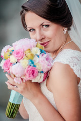 Wedding. Beautiful bride with bouquet. Woman close up with flowers.