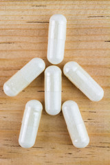 Food supplement pills, glucosamine capsules in shape of human, top view