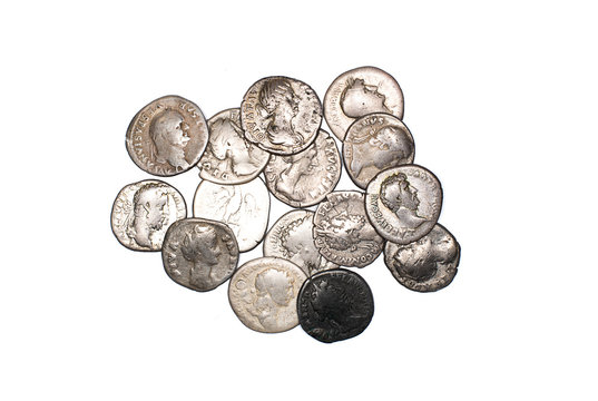 Many ancient silver coins on over white