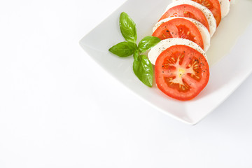 Caprese salad with mozzarella cheese, tomatoes and basil isolated on white background

