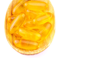 Full spoon of fatty acid, omega 3 capsules isolated on white background.