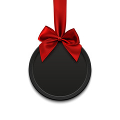 Blank, black round banner with red ribbon and bow.