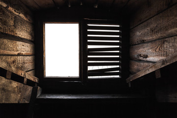 Attic window with shutters in old wooden interior