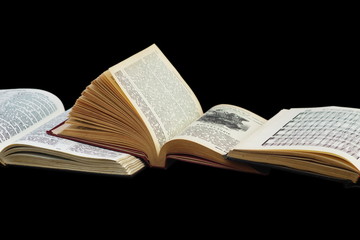 Open books isolated on a black background