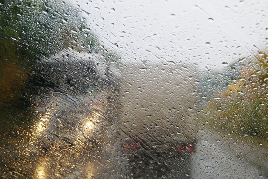 Raindrops on the windshield of the car.