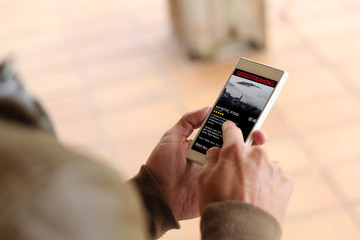 Brown young man smartphone video streaming