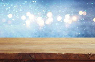 Empty table in front of blue glitter lights background