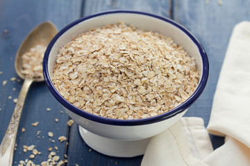 oat on white bowl on wooden background