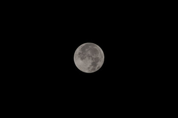 Full moon on the dark night. Full moon over dark black sky at night.