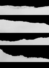 torn or ripped pieces of paper in black background