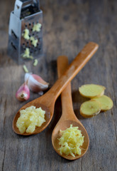 garlic and ginger in wooden spoons