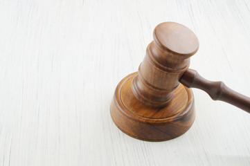 Judge gavel on white table with room for text