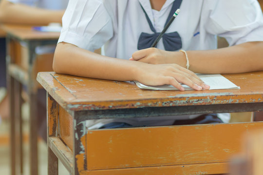 Thai students writing on a paper for Admissions in high school,