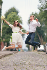 Elegant bride and groom posing together outdoors on a wedding day