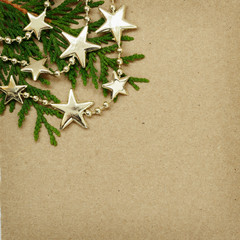 Brown cardboard with evergreen twigs and Chrisrmas garland