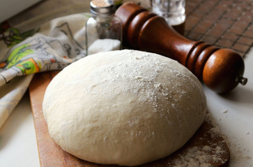 Yeast dough lying on the board.