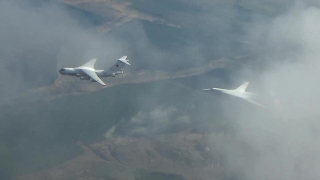 Two planes fly in a refueling system