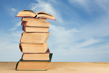 stack of books over the natural background