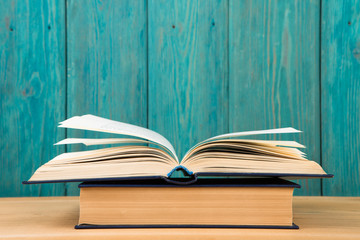 Open book on the desk over wooden background