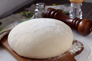 Yeast dough lying on the board.