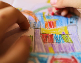 boy draws with colored pencils