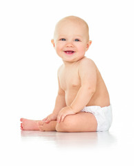 Beautiful smiling baby sitting on the floor. One, isolated on wh