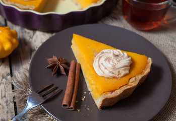 Festive Thanksgiving Homemade Pumpkin Pie with Whipped Cream on rustic wooden background