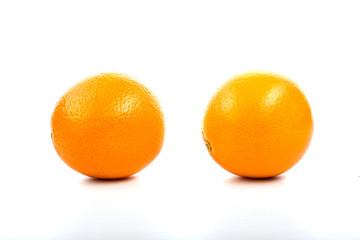 Bananas, oranges and pineapple on the table on a white backgroun