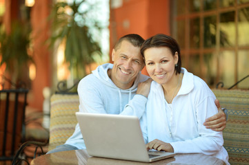 Happy couple with laptop