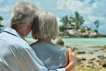 elderly couple rest at tropical beach